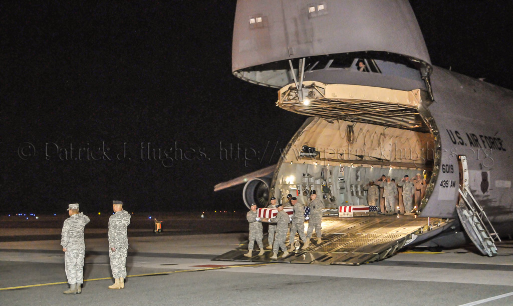 Army carry team carries the transfer case containing the remains of Spc. Christopher B. Fishbeck, 24, of Victorville, CA  upon arrival at Dover Air Force Base, DE on June 8, 2011. The Department of Defense announced the death of Fishbeck who was supporting Operation  New Dawn in Iraq.