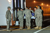 Army carry team moves the transfer case with the believed to be remains of Pfc. Michael C. Olivieri into mortuary transfer vehicle.