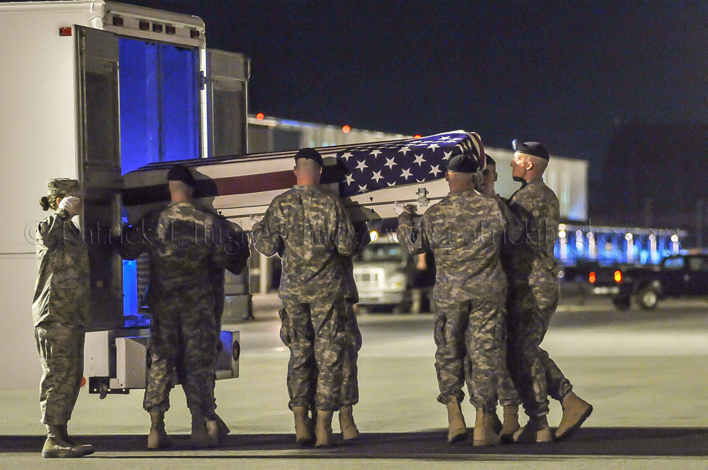 Army carry team moves the transfer case with the believed to be remains of Capt. Michael W. Newton into mortuary transfer vehicle.