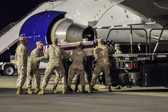 A Marine carry team carries the transfer case containing the remains of L/Cpl. Jason D. Hill, 20, of Poway, CA  upon arrival at Dover Air Force Base, DE on June 14, 2011. The Department of Defense announced the death of Hill who was supporting Operation Enduring Freedom – Afghanistan.
