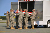 Army carry team moves the transfer case with the believed to be remains of Sgt. Colby L. Richmond into mortuary transfer vehicle.