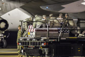 Transfer case of Cpl. Joseph D. Logan is moved into position on K-loader