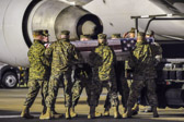 Marine carry team carries transfer case of Cpl. Joseph D. Logan  to the mortuary transfer vehicle