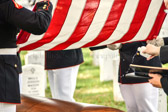 Navy Chaplain sprinkles Holy Water onto the casket of 2nd Lt George S. Bussa