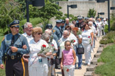 New Jersey State Police officer leads National Gold Star Mother President Judith Young to the New Jersey Vietnam Veterans' Memorial