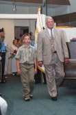 Gold Star Dad Jack Young enters with his grand son.