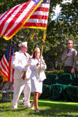 Gold Star Mother Marcy Cote' proudly carrying the Stars and Stripes while retiring the Colors.