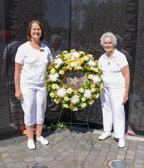 Vietnam PNP Gold Star Mother Terry Davis and Gold Star Mother Jennifer Jackman, 2014-2015 Gold Star Mother President place the wreath at the apex of The Wall.
