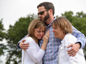 Michael C. Hardegree best friend and service buddy comforts Gold Star Mother Cindy Kruger and Gold Star Mother Jo Ann Maitland.