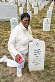 Gold Star Mother Mona Gunn knells at the grave of  2nd Class Petty Officer Mark A. Mayo.<br />Master-at-Arms 2nd Class Petty Officer Mark A. Mayo was killed by civilian Jeffery Tyrone Savage.  Mayo was performing duties as the chief of the guard at Naval Station Norfolk at the time. Officials say Savage was allowed access onto the base at around 11:30 p.m. and Mayo followed him up the brow of the USS Mahan. Watch standers told him to stop and show an ID but he failed to comply.<br />Savage got onto the ship and attacked and disarmed the Petty Officer of the Watch on the Quarterdeck. To protect his shipmate, Mayo shielded the Petty Officer and was fatally shot. Savage was then shot and killed by watch standers. He died at the scene.