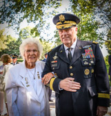 Vietnam Gold Star Mother Emogene Cupp is escorted to her seat by General Mark A. Milley, Chief of Staff of the Army.