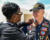National President Mona Gunn pins Vietnam Veteran Chuck Hasford (Air Force ~  Marine Vet)