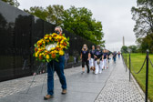 Jim Knotts, President, CEO of the Vietnam Veterans Memorial carries wreath to the apex of ‘The Wall’