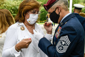Ramón Colón-López SEAC, Senior Enlisted Advisor to the Chairman of the Joint Chiefs of Staff admires a necklace worn by Gold Star Mother Rose Duval, proud Mother of TSgt. Scott E. Duffman, KIA 2/17/2007