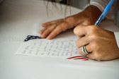 Maria Lee, wife of Tennessee Governor Bill Lee signs a note to a Veteran that will receive a package to be delivered to the Memphis VA Medical Center.