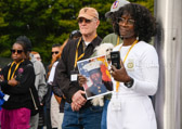 Major General Peter M. Aylward (USA Ret) and Gold Star Mom Sandra C. Johnson, holding picture of her only son Marine PFC. Michael Anthony Cater, Jr. listening to Patti Elliott remarks.