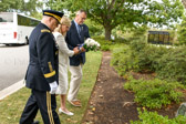 Gold Star Mothers National President Sarah Taylor places the spray of eleven white Niphoes roses, “Society’s Never Forget Bouquet” at the Mother’s Tree.