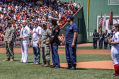 Service members getting ready to throw out the First pitch