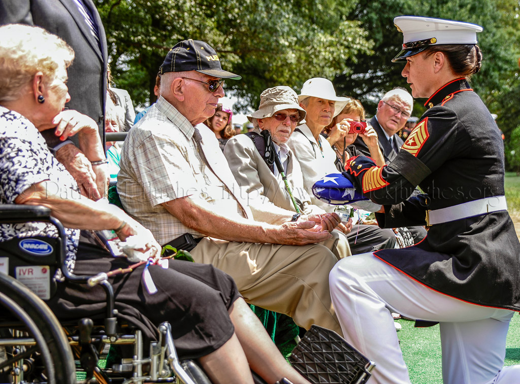 Marine Corps Sergeant Major Angela M. Maness presents the national colors to the family of  PFC Jonathan Reed Posey, Jr.