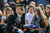 Art's wife Molly is presented with his American flag