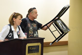 Rolling Thunder Secretary Elaine Martin show off another version of the POW-MIA National Chair of Honor.