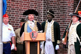 Reenactor Barry Kelly as George Washington reading a letter to his troops.