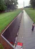 Maya Lin conceived her design as creating a park within a park — a quiet protected place unto itself, yet harmonious with the overall plan of Constitution Gardens. To achieve this effect she chose polished black granite for the walls. Its mirror-like surface reflects the images of the surrounding trees, lawns, and monuments.