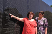 Terri Jackson pointing out her brother’s name, Capt. Edward F. Miles, US Army, to Holly Rotondi, Vice President Vietnam Veterans Memorial Fund.