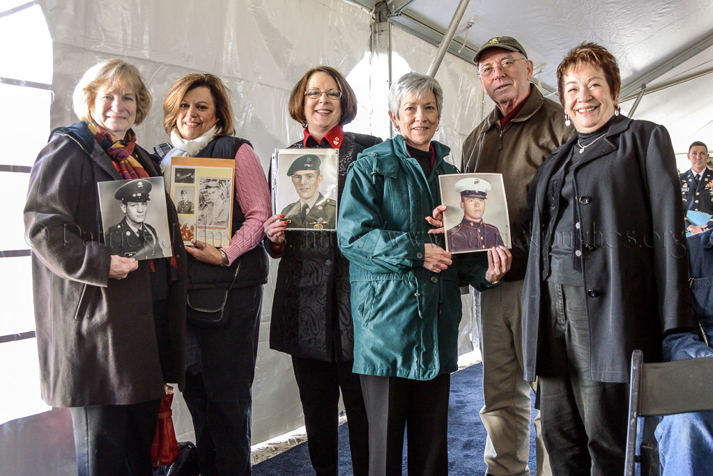 A group of Gold Star family members from Delaware proudly show off photographs of their loved ones.