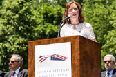 Founder and President of the Vietnam Women's Memorial Foundation Diane Carlson Evans, who served in the Army Nurse Corps in Vietnam, praised the 11,000 military women who served during the war. Evans was the driving force for the seven-foot-tall sculpture depicting three women supporting a wounded Soldier. The Vietnam Women's Memorial was dedicated on Veteran's Day, 1993.