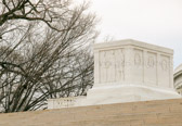 Under authority of Public Law 429, 79th Congress, Approved 24 June 1946. 13 Unknown Americans who lost their lives while serving overseas in the Armed Forces of the United States during World War II were exhumed from American cemeteries in Europe and Africa and shipped in identical caskets to Epinal, France. Major General Edward J. O'Neill, US Army, on May 12, 1958, solemnly chose from among these caskets one to be designated as the Trans Atlantic candidate Unknown. The remaining unknown Americans were reinterred. The remains of two unknown Americans were disinterred on April 15, 1958 from the National Cemetery of the Pacific, Hawaii, and four unknowns were disinterred from the Fort McKinley American Cemetery and Memorial in the Philippines. The six unknowns were then taken to Hickam Air Force Base, where on May 16, 1958, Colonel Glenn T. Eagleston, US Air Force, placed a white carnation lei, selecting the candidate Unknown to represent the Trans Pacific Phase of World War II. The five other caskets were reinterred. The candidate unknown was then transported to the cruiser Canberra where the final selection of the World War II unknown took place on the after-missile deck of the Canberra. Hospitalman First Class William R. Charette, the Navy's only active enlisted holder of the Medal of Honor, had the distinction of making the selection of the World War II unknown. After a moments hesitation he placed a wreath at the foot of the casket on his right. This was the Unknown of World War II. The unknown not selected received a sailor's burial at sea.