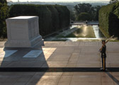 The Tomb Guard marches 21 steps down the black mat behind the Tomb, turns, faces east for 21 seconds, turns and faces north for 21 seconds, then takes 21 steps down the mat and repeats the process. After the turn, the sentinel executes a sharp 'shoulder-arms' movement to place the weapon on the shoulder closest to the visitors to signify that the sentinel stands between the Tomb and any possible threat. Twenty-one was chosen because it symbolizes the highest military honor that can be bestowed -- the 21-gun salute.