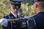 As the new sentinel approaches the relief commander slowly and with great precision, conducts a white-glove inspection of the sentinel's weapon.