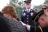 Sgt. Jonathan Merck comforts Patti Elliott.