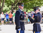 An impeccably uniformed relief commander conducts a detailed white-glove inspection of the Tomb Guards M-14 rifle, checking each part of the rifle once.