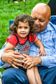 Gold Star Father of Army Sgt. 1st Class Carlos M. Santos-Silva  playing with his grand daughter.