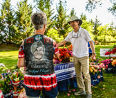 Memorial Day Flowers director Ramiro Peñaherrera explaining to this Gold Star Mother that <br />over Memorial Day Weekend 5000+ volunteers will place flowers at 600,000 gravesites