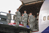 Once the aircraft lands at Dover, service-specific carry teams remove the transfer cases individually from the aircraft and move them to a waiting mortuary transport vehicle. Once all of the transfer cases have been taken to the transport vehicles, they are then taken to the port mortuary.