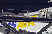 Transfer case is moved into position on K-loader prior to being lowered to the ground