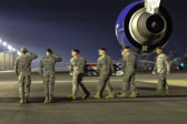 Dignified transfer officer orders “Present, Arms” (slow movement salute)