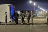 Carry team moves transfer case into the mortuary transfer vehicle