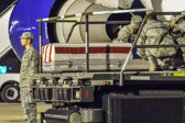 Transfer case of Pfc. Brandon A. Owens is moved into position on K-loader