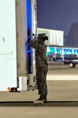 Transfer vehicle guide Airman Lisibeth Payano slowly closes the doors to transfer vehicle