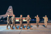Dignified transfer officer orders “Present, Arms” (slow movement salute)