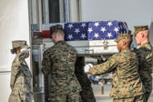 Carry team moves transfer case into the mortuary transfer vehicle