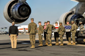 Marine carry team carries transfer case of L/Cpl James T. Poole, Jr. from end of 747 K-loader to the transfer vehicle