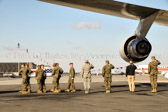 Dignified transfer officer orders “Present, Arms” (slow movement salute)