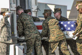 Carry team moves transfer case into the mortuary transfer vehicle
