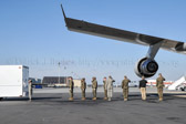 Mortuary vehicle driver starts engine, and Security Forces vehicle moves into escort position in front<br />Transfer vehicle begins to pull away