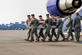 The dignified transfer officer orders “Present, Arms” (slow movement salute).